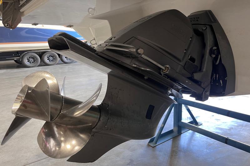 Close-up of Volvo Penta dual-prop drive unit on 2015 Cobalt R7 in indoor storage.