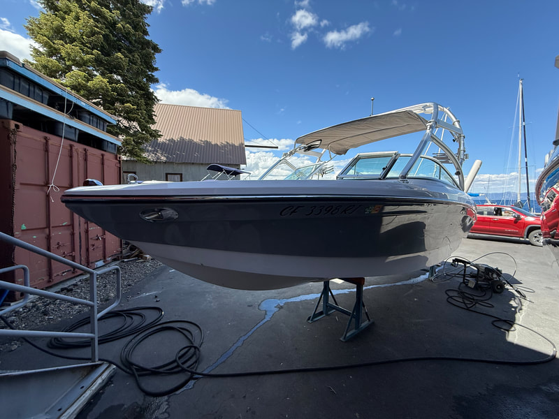 Port side angle of 2007 Air Nautique with tower and red hull reflection
