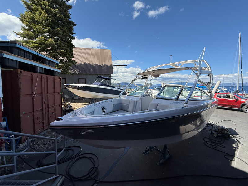 Starboard side view of 2007 Air Nautique 236 TE parked near dock