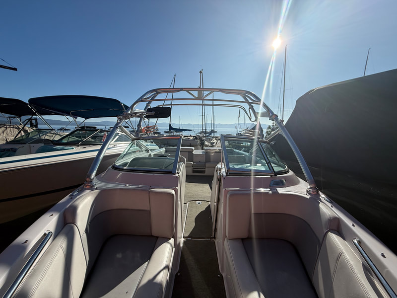Close-up of helm, throttle controls, and captain’s seat